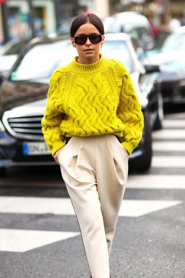 Miroslava Duma in bright yellow, oversized, cabled sweater and pleaded pants. Very chic! Paris Fashion Week, Street style.