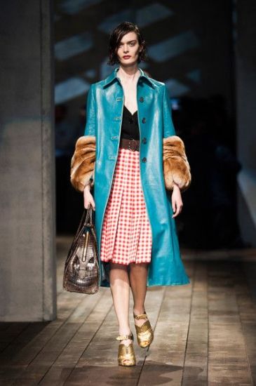 Prada runway in Milan - blue leather coat with fur sleeves, pleated and patterned midi skirt, black top, golden high heels and reptile skin bag!
