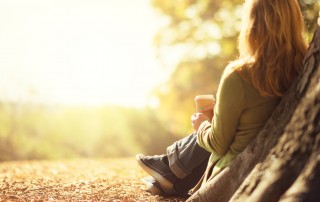 woman sitting under tree