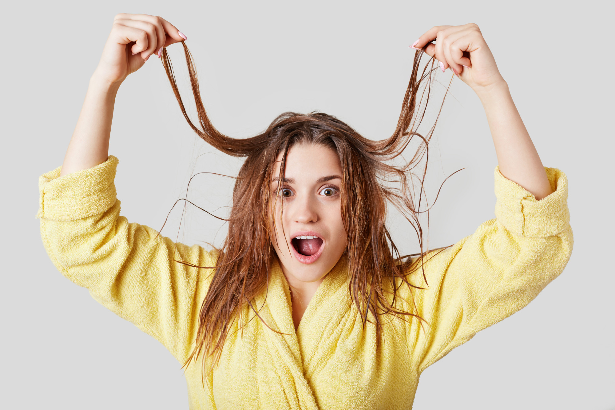 woman holding up hair