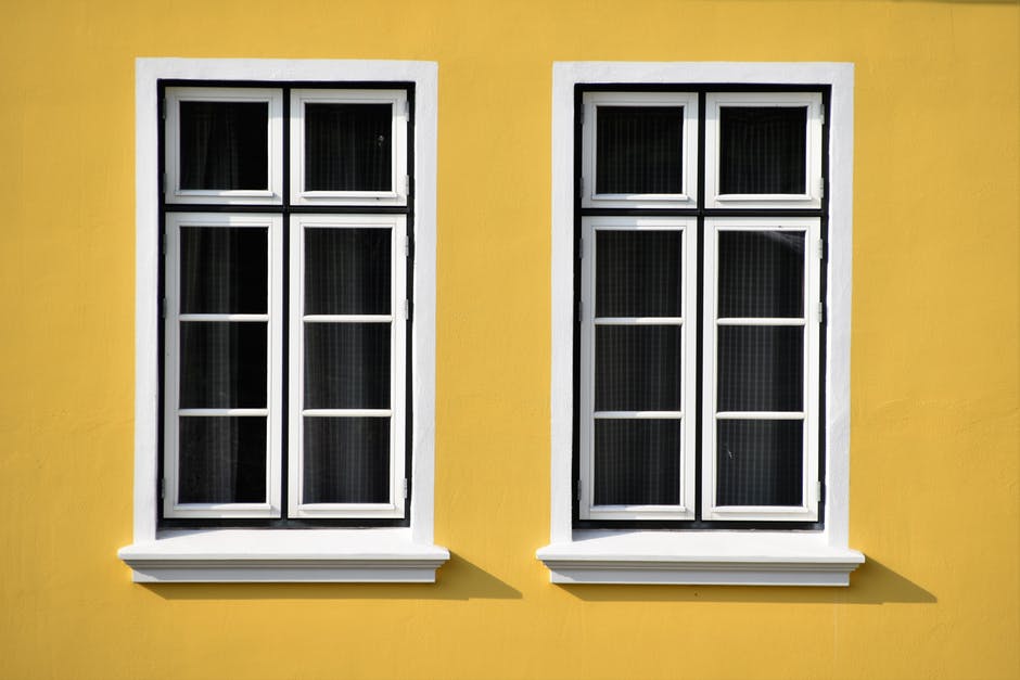 windows on yellow house