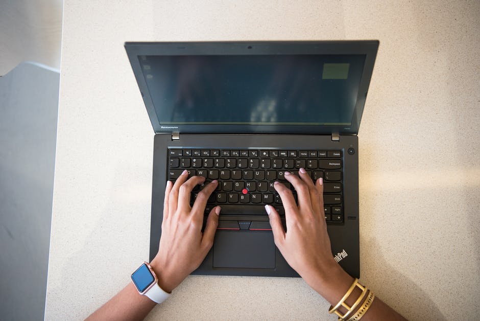 woman with bracelets on laptop