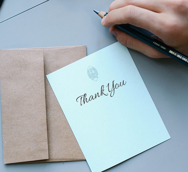 thank you card and hand with pencil