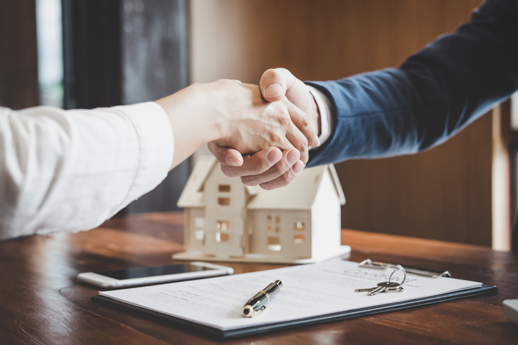 real estate agent shaking hands with client