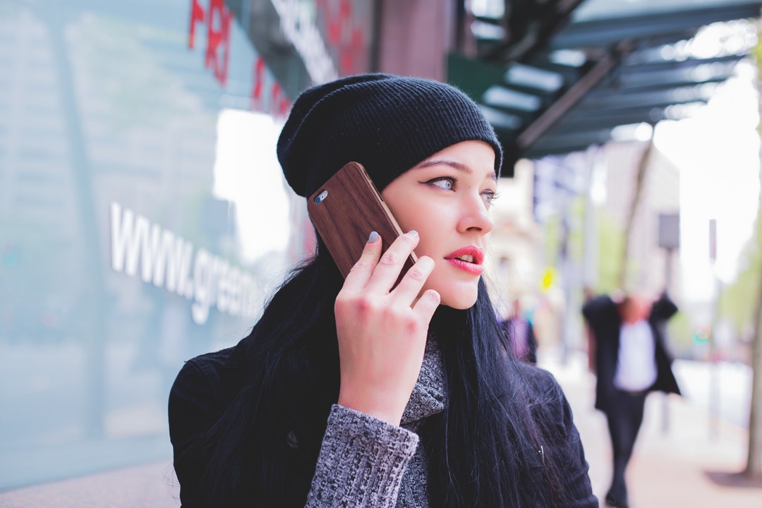 woman in winter clothes on phone