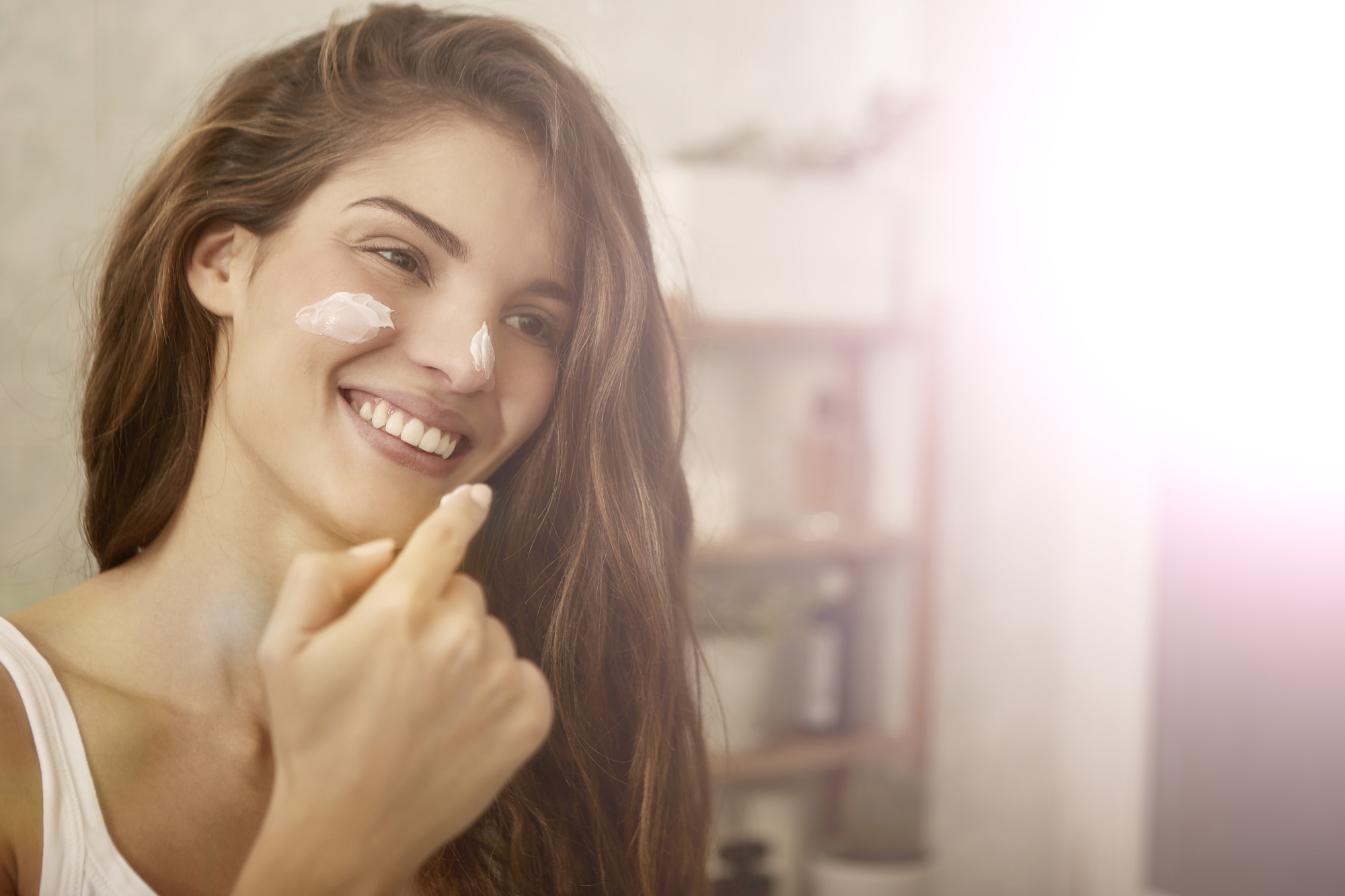 Woman Applying Vegan - Based Skin Care Product