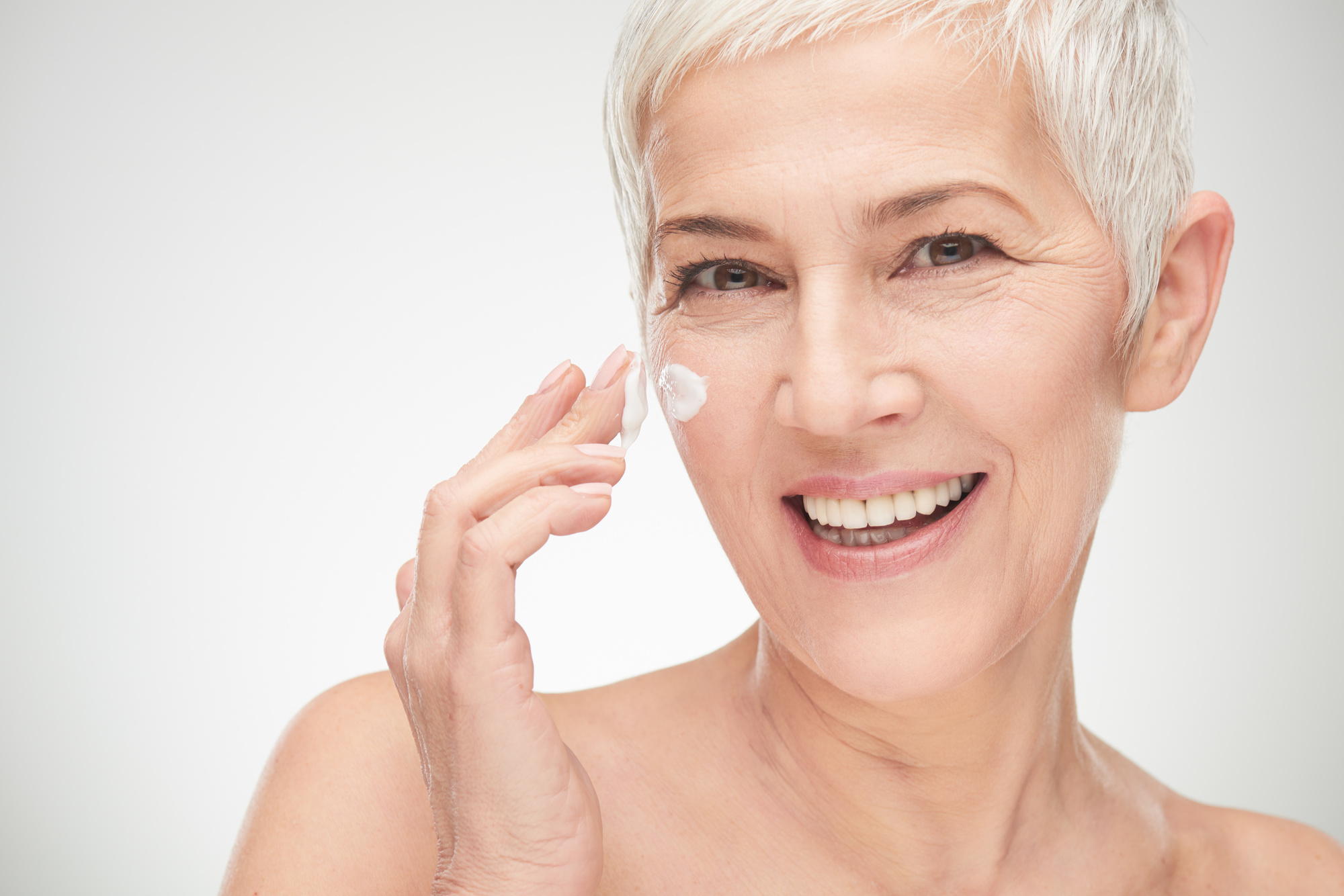 Old Woman Applying Stem Cell Anti Aging Cream